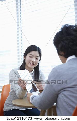 Stock Image - mother and daughter having a chat about tablet PC. Fotosearch