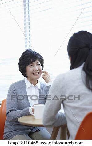 Stock Photo - mother and daughter having a chat. Fotosearch