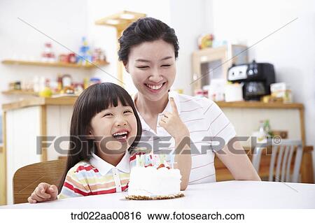 mother and daughter in front of birthday cake View Large Photo Image Stock Photograph - mother and daughter in front of birthday cake. Fotosearch