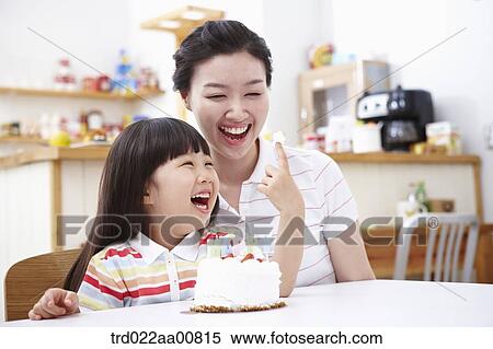 mother and daughter in front of birthday cake View Large Photo Image Stock Photography - mother and daughter in front of birthday cake. Fotosearch