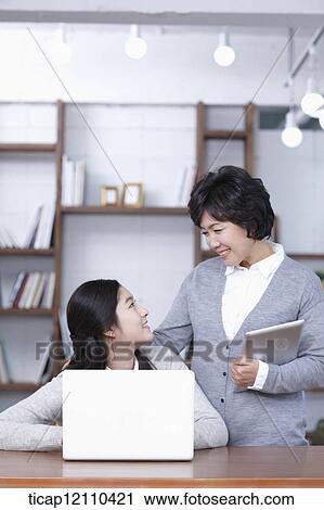 Stock Image - mother and daughter in study room. Fotosearch