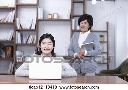 Stock Photo - mother and daughter in study room. Fotosearch
