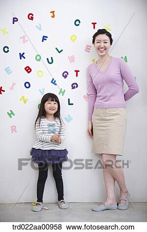 mother and daughter playing with alphabet blocks on the wall View Large Photo Image Stock Photo - mother and daughter playing with alphabet blocks on the wall. Fotosearch