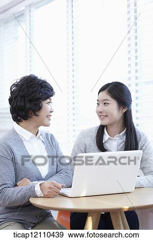 mother and daughter sharing a laptop View Large Photo Image Stock Photo - mother and daughter sharing a laptop. Fotosearch