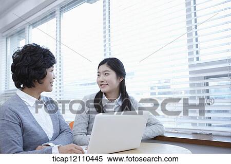 Stock Photography - mother and daughter sharing a laptop. Fotosearch