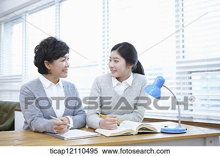 mother and daughter sitting together in the classroom View Large Photo Image Stock Photography - mother and daughter sitting together in the classroom. Fotosearch