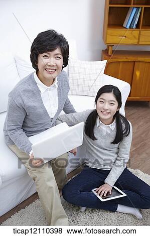 mother and daughter using smart devices View Large Photo Image Stock Photo - mother and daughter using smart devices. Fotosearch