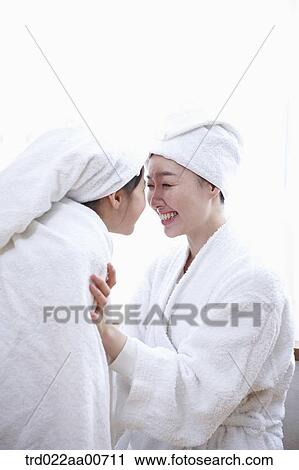 Stock Image - mother and daughter with bathrobe. Fotosearch