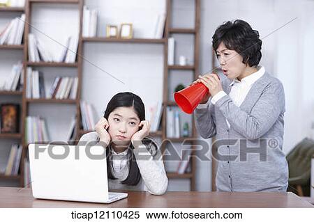Stock Photography - mother scolding daughter with megaphone. Fotosearch