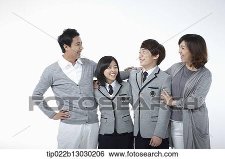 Stock Photograph - parents next to children with school uniforms. Fotosearch