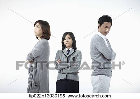 Stock Photography - parents scolding at a daughter with a school uniform. Fotosearch