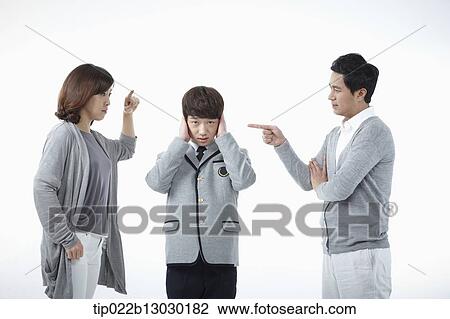 Stock Image - parents scolding at a son with a school uniform. Fotosearch