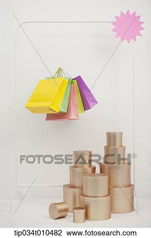 Stock Image - piles of golden boxes and shopping bags. Fotosearch