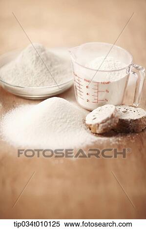 Stock Photography - powders on cup with a baguette. Fotosearch