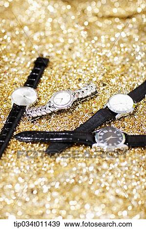several watches lying on gold textile View Large Photo Image Stock Photo - several watches lying on gold textile. Fotosearch