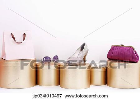 Stock Photo - shopping items on golden boxes. Fotosearch