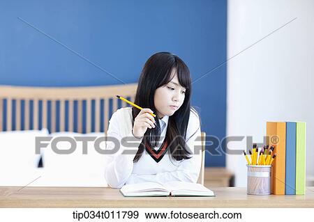 Stock Photo - students in uniform at a desk. Fotosearch