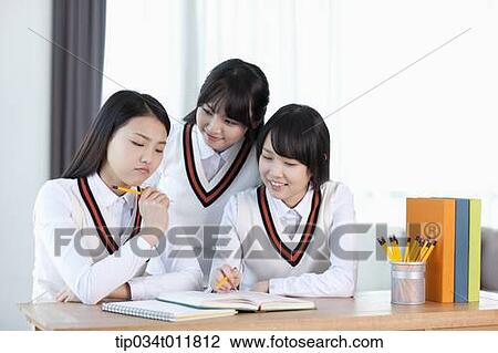 students in uniform at a desk studying together View Large Photo Image Stock Image - students in uniform at a desk studying together. Fotosearch