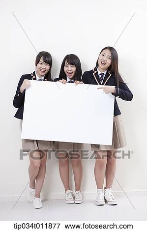 Stock Photo - students in uniform posing with a white board. Fotosearch