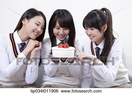 students in uniform sitting on a couch with a cake View Large Photo Image Stock Photograph - students in uniform sitting on a couch with a cake. Fotosearch