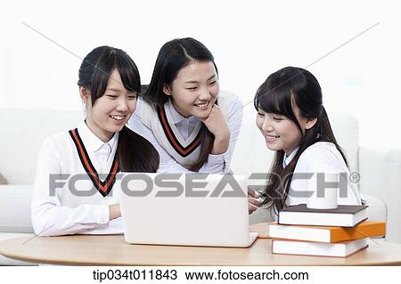 students in uniform studying together in a room View Large Photo Image Stock Image - students in uniform studying together in a room. Fotosearch