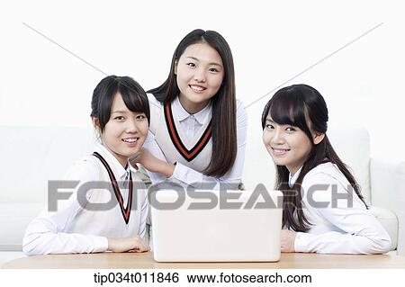 students in uniform studying together in a room View Large Photo Image Stock Photograph - students in uniform studying together in a room. Fotosearch