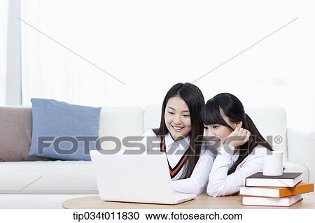 students in uniform using laptop together View Large Photo Image Stock Image - students in uniform using laptop together. Fotosearch