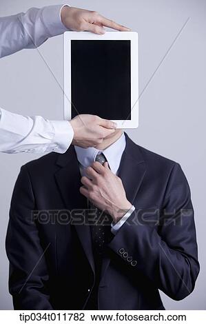 Stock Image - tablet PC in front of a businessman . Fotosearch