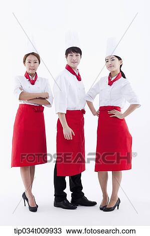 three cook with chef hats posing together in white background View Large Photo Image Stock Image - three cook with chef hats posing together in white background. Fotosearch