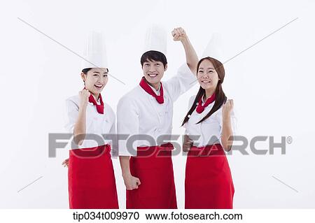 three cook with chef hats posing cheerfully View Large Photo Image Stock Image - three cook with chef hats posing cheerfully. Fotosearch