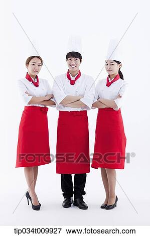 Stock Photo - three cook with chef hats posing together in white background. Fotosearch