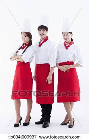 Stock Photo - three cook with chef hats posing together in white background. Fotosearch