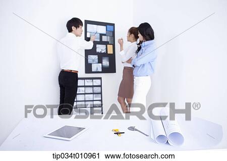 three interior designers working on a portfolio View Large Photo Image Stock Image - three interior designers working on a portfolio. Fotosearch