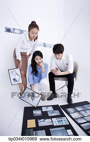 three interior designers working on a portfolio View Large Photo Image Stock Photo - three interior designers working on a portfolio. Fotosearch