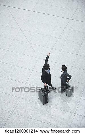 Picture - top down view of businesswoman and businessman having a chat. Fotosearch