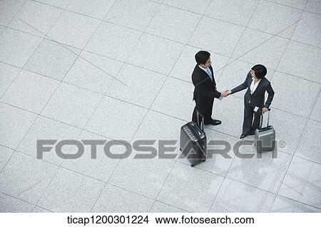top down view of businesswoman and businessman shaking hands View Large Photo Image Picture - top down view of businesswoman and businessman shaking hands. Fotosearch