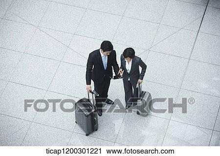 Stock Image - top down view of businesswoman and businessman having a chat. Fotosearch