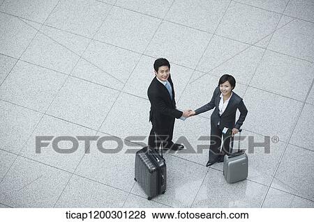 Stock Photo - top down view of businesswoman and businessman shaking hands. Fotosearch
