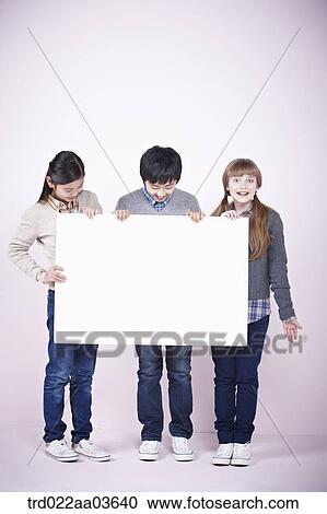 two girls and a boy holding blank board View Large Photo Image Stock Image - two girls and a boy holding blank board. Fotosearch