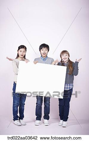two girls and a boy holding blank board View Large Photo Image Stock Image - two girls and a boy holding blank board. Fotosearch