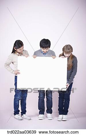 two girls and a boy holding blank board View Large Photo Image Stock Photo - two girls and a boy holding blank board. Fotosearch