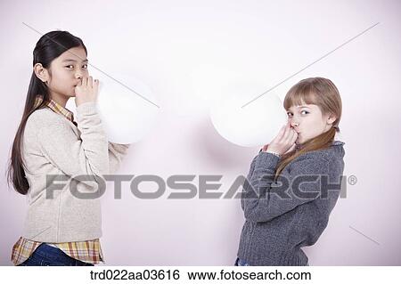 two girls blowing white balloons View Large Photo Image Stock Photograph - two girls blowing white balloons. Fotosearch