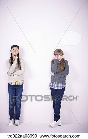 two girls standing together View Large Photo Image Stock Photo - two girls standing together. Fotosearch