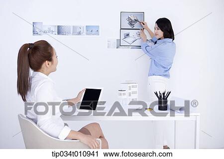 two interior designers looking at pictures View Large Photo Image Stock Image - two interior designers looking at pictures. Fotosearch