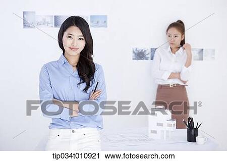 two interior designers with a model house View Large Photo Image Stock Image - two interior designers with a model house. Fotosearch
