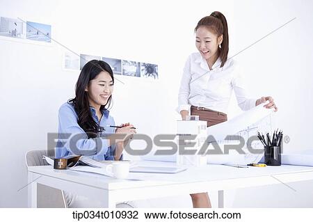 Stock Image - two interior designers working on a project. Fotosearch