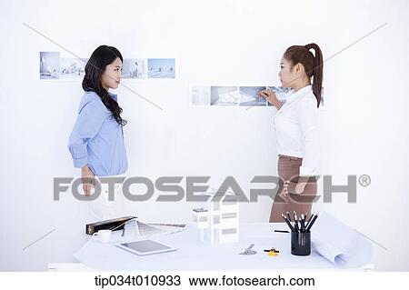 Stock Image - two interior designers working on a project. Fotosearch