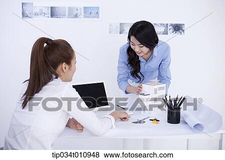 Stock Photo - two interior designers working on a project. Fotosearch