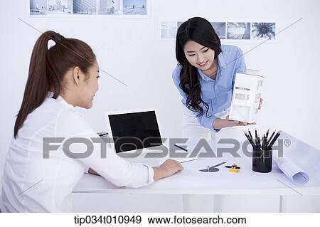 Stock Photo - two interior designers working on a project. Fotosearch