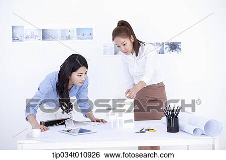 Stock Photograph - two interior designers working on a project. Fotosearch